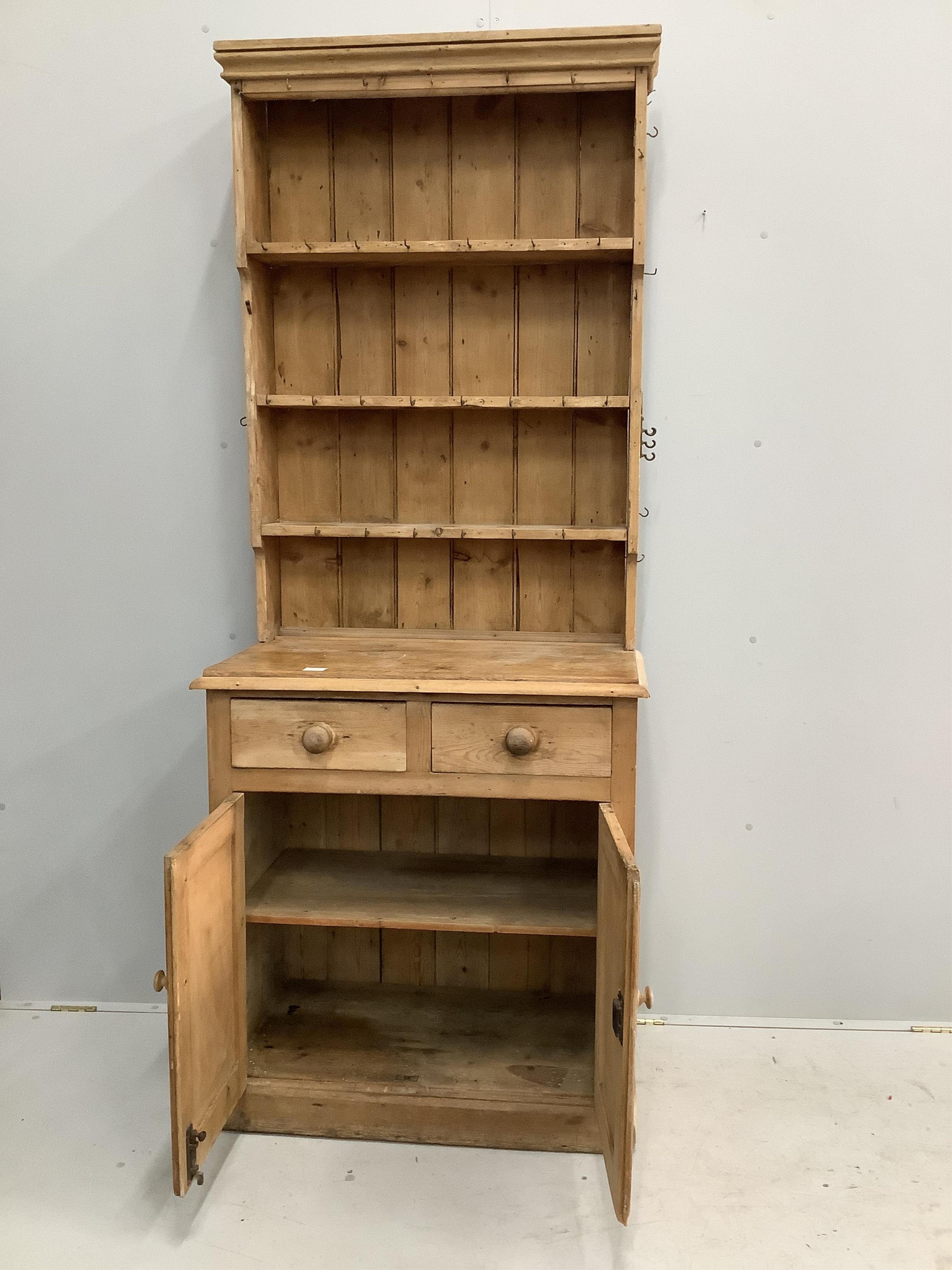 A narrow Victorian style pine dresser with boarded rack, width 85cm, depth 48cm, height 210cm. Condition - fair